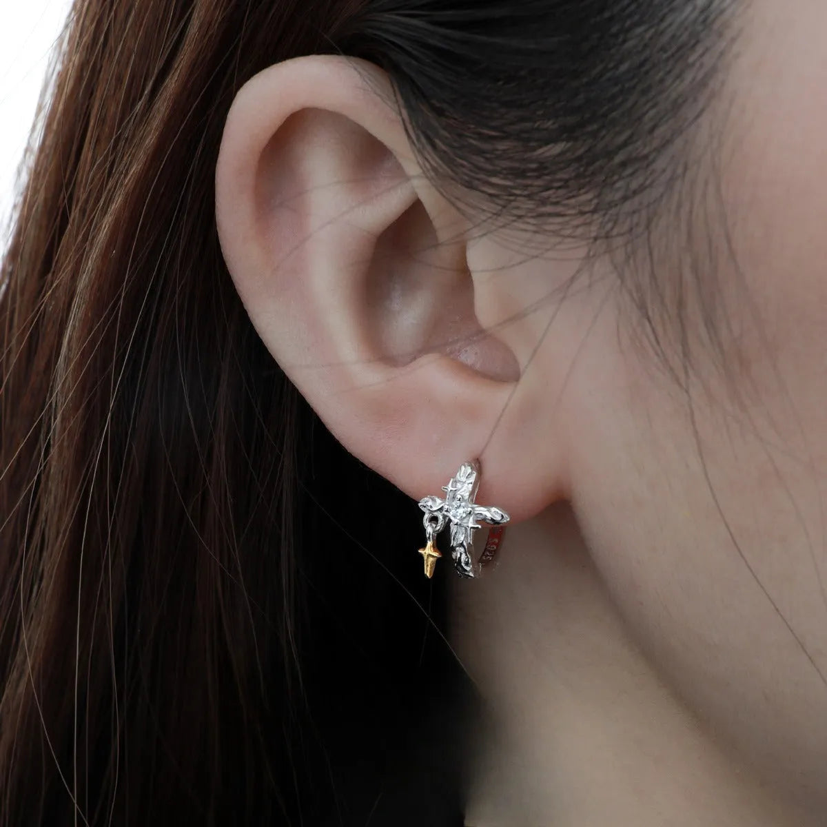 XINGX geometric cross earrings in 925 silver with white gold electroplated finish and circular detail.