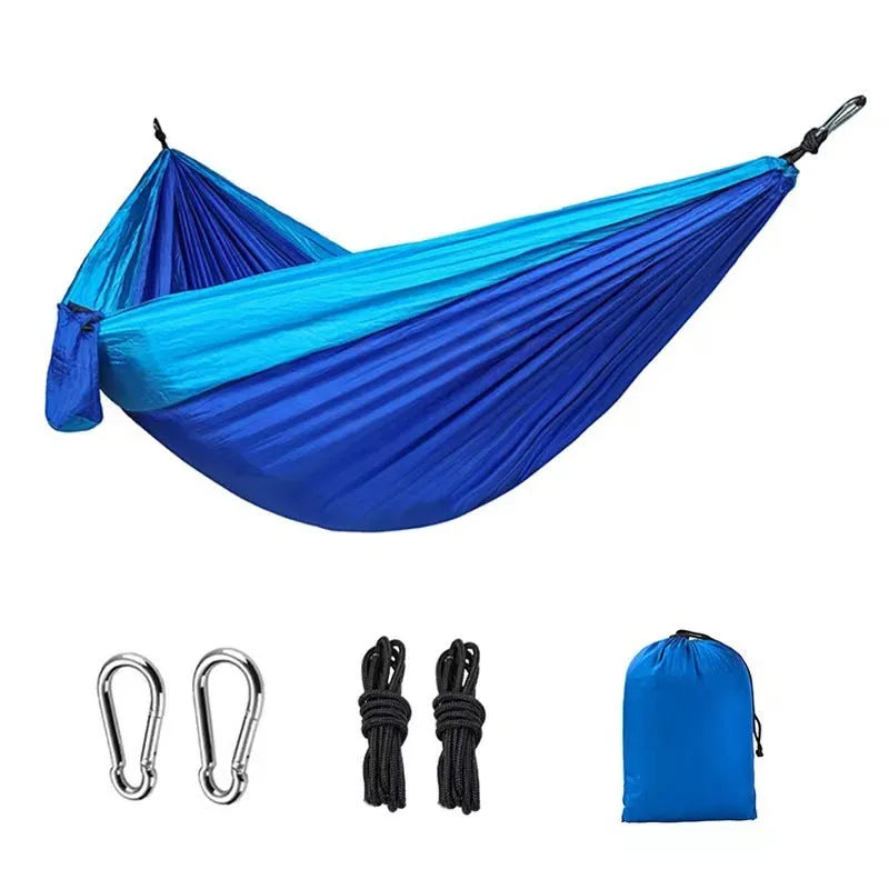 Blue parachute cloth nylon camping hammock shown hung between trees with 270cm length