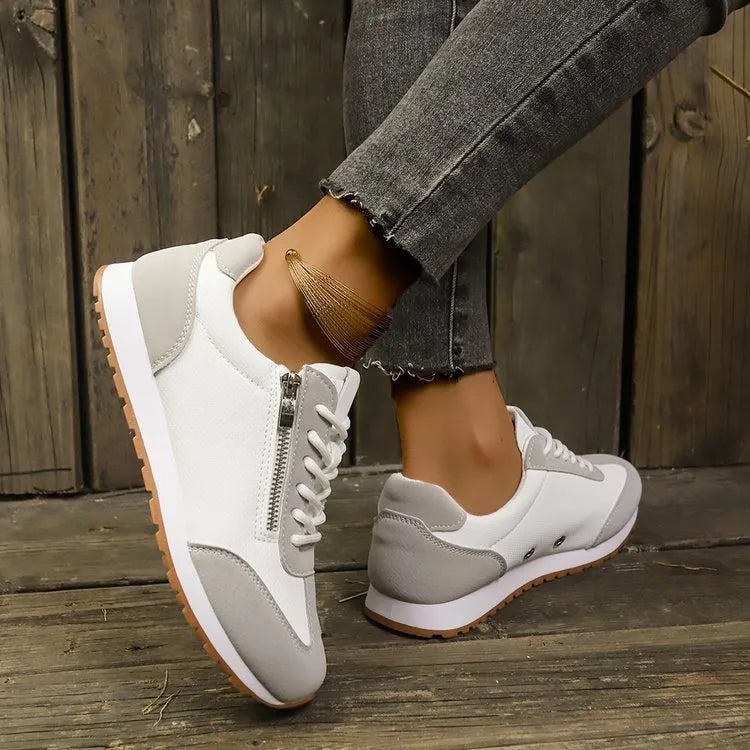 Women's flat-heeled shoes in artificial PU, available in Champagne, Gray, and White colours with a rubber sole.