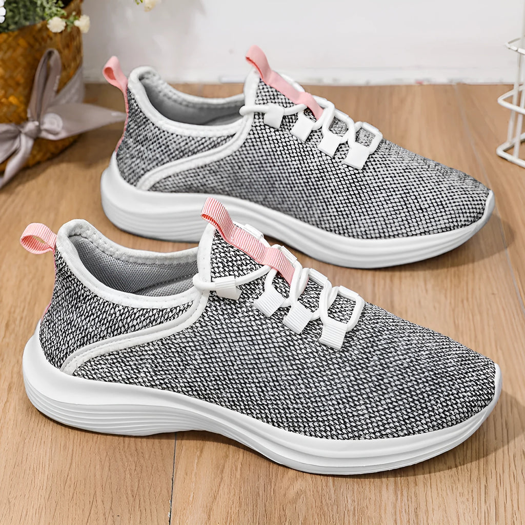 Women's low-top Flyknit mesh sneaker in black with round toe and lace-up front.