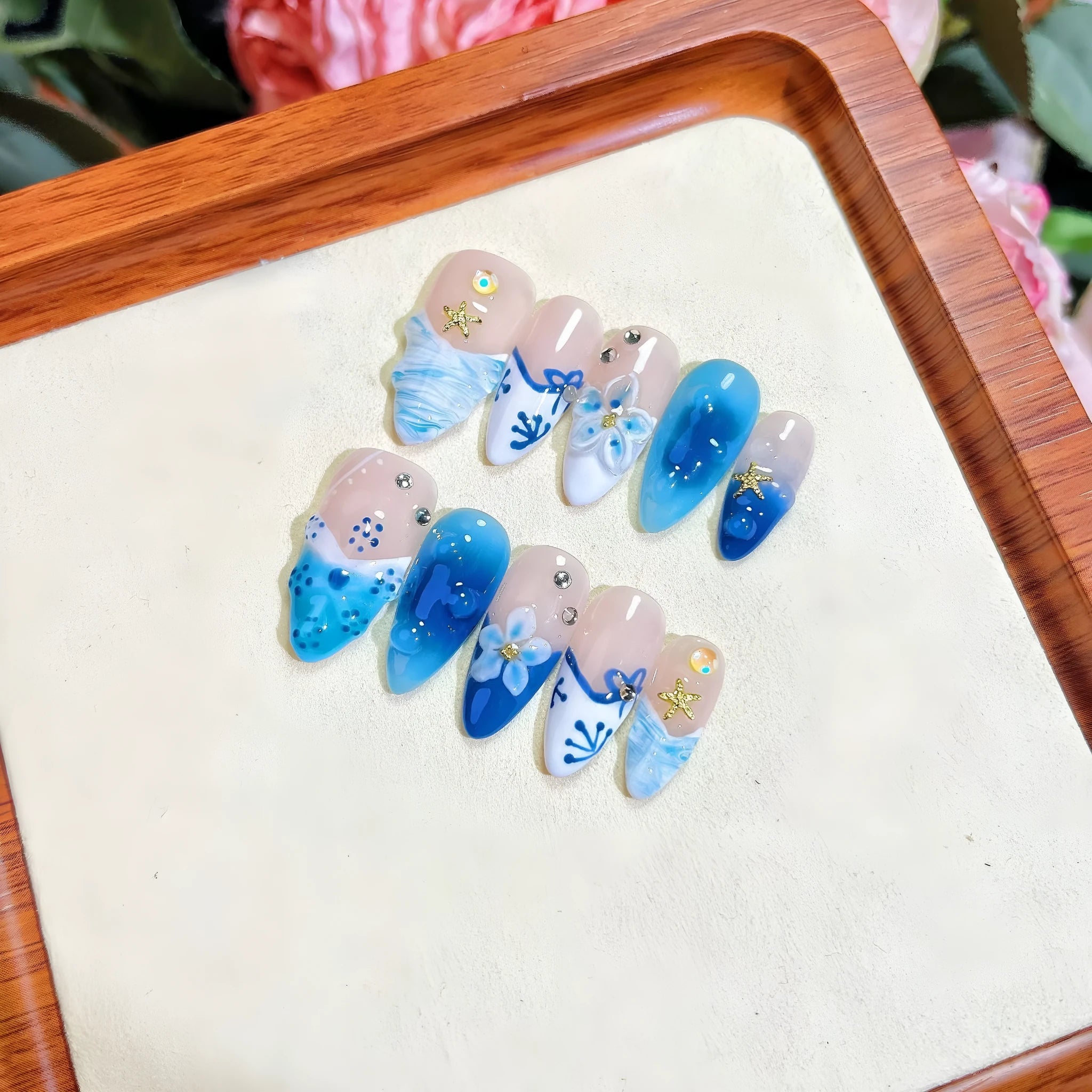 Blue hand-painted fake nails with carved transparent summer ice finish in four sizes
