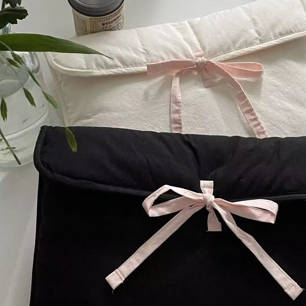 Women's black and white quilted nylon computer bag with ballet bow detailing and striped pattern