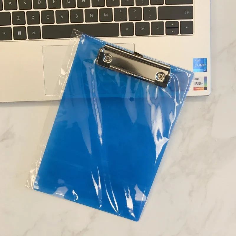 Transparent A4 plastic writing board pad with a silver metal clip, shown in blue colour.