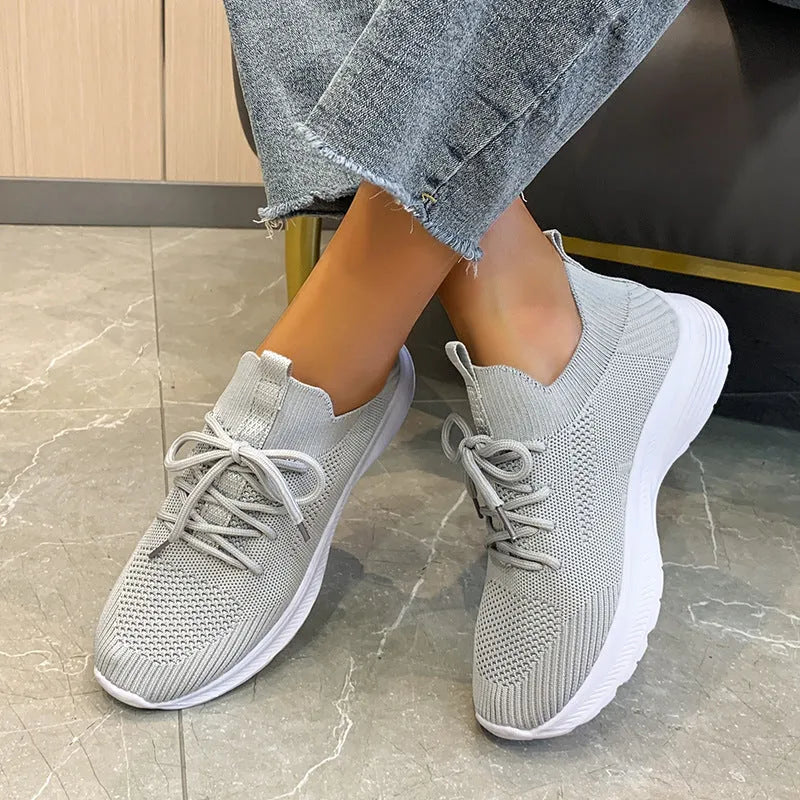Women's mesh running shoes in Creamy White colour with Flyknit upper and rubber sole