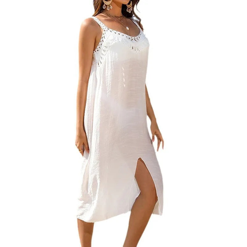 White suspender-style crochet beach dress with a thigh slit on an adult female mannequin.