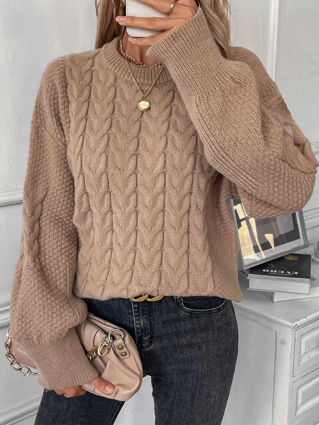 Women's beige loose-fit round neck casual pullover sweater on a hanger.