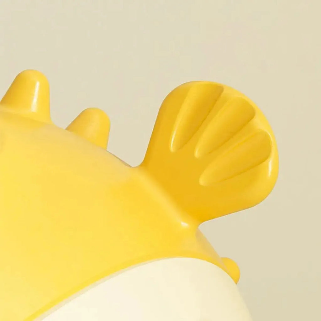 Yellow fish-shaped vinyl dog chew toy with textured surface and squeaker for aggressive chewers
