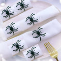 Six black metal spider napkin rings for Halloween table decoration