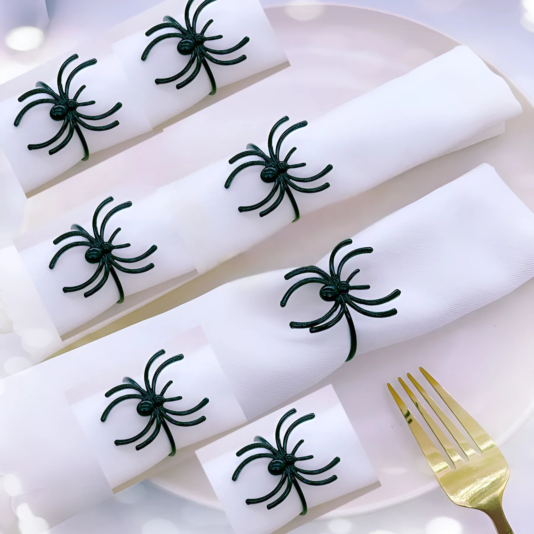 Six black metal spider napkin rings for Halloween table decoration