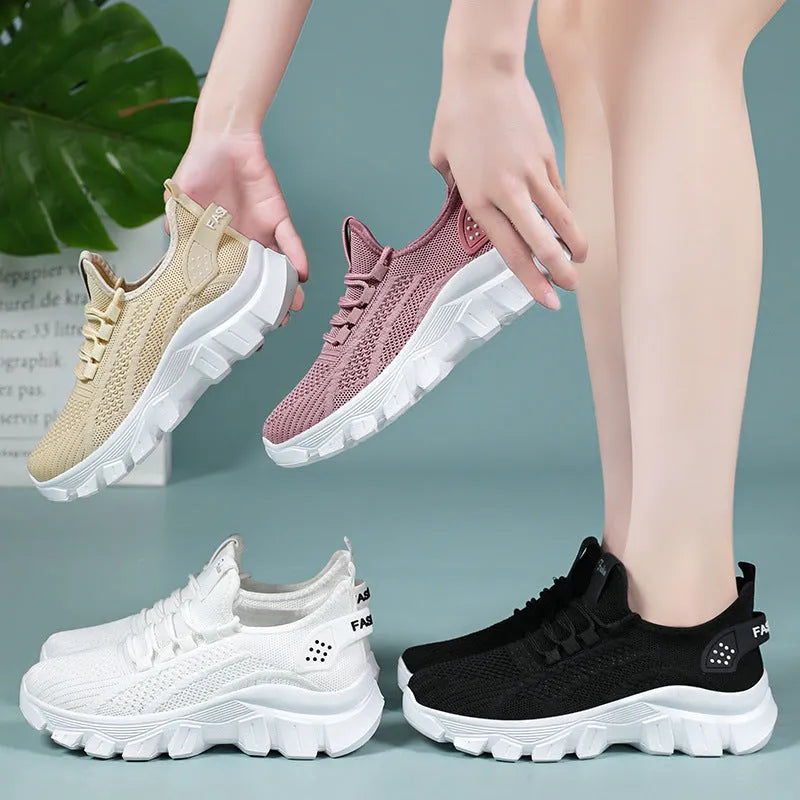 Women's white Flyknit sneakers with a thick PVC sole and front lace-up on a plain background.