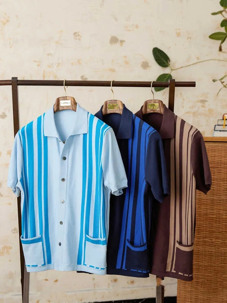 Royal blue striped short-sleeved knitted cardigan polo shirt with a lapel collar laid flat.