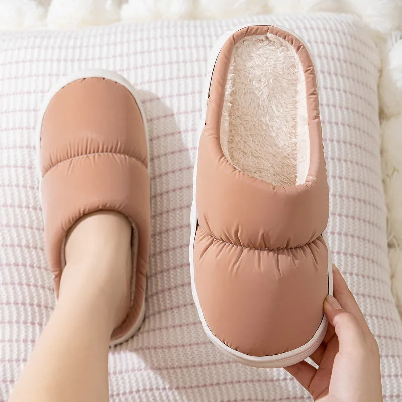 Pair of thick-soled winter slippers with artificial leather upper and plush lining, shown in a choice of colours.