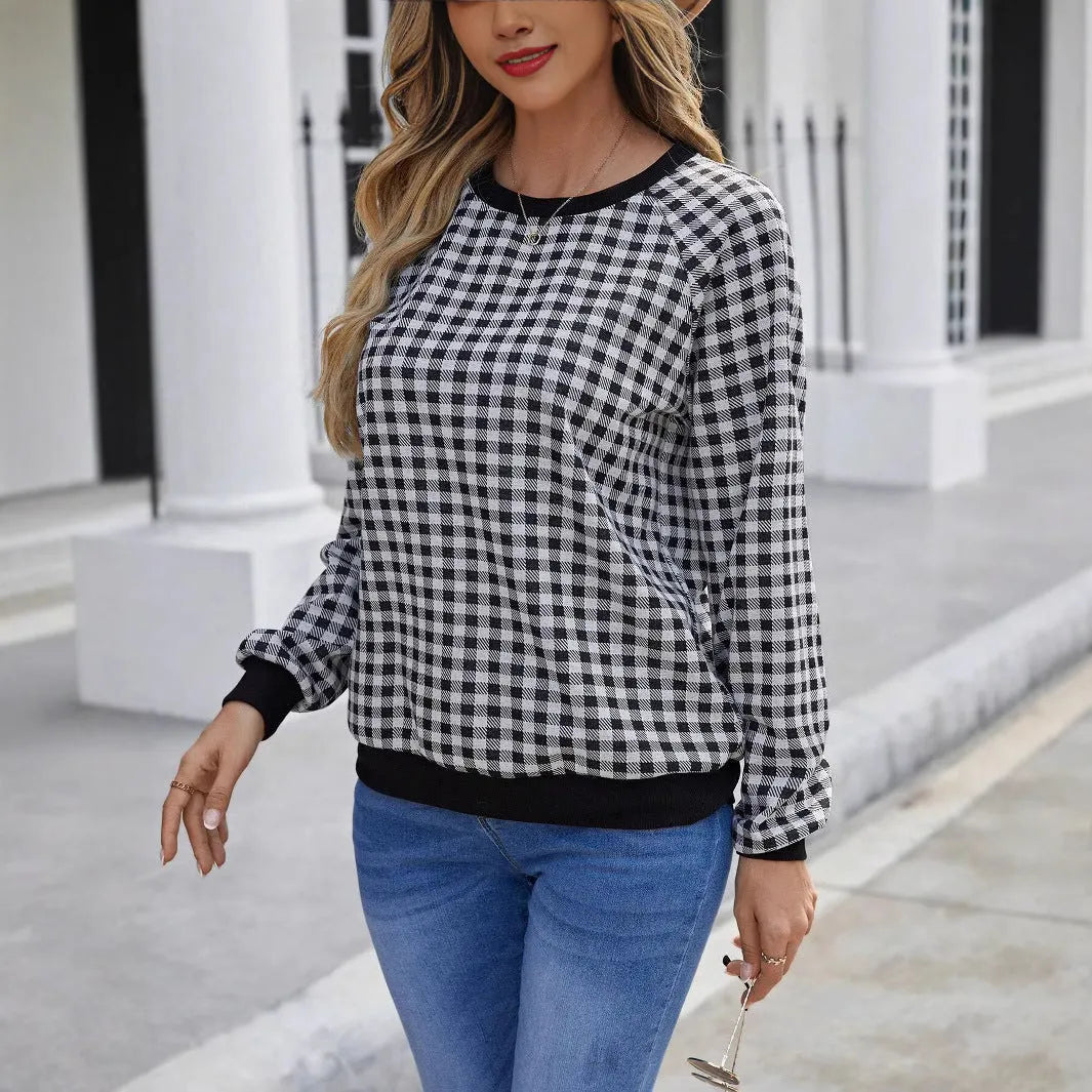 Black long sleeve pullover sweater with printed plaid and stripe pattern.