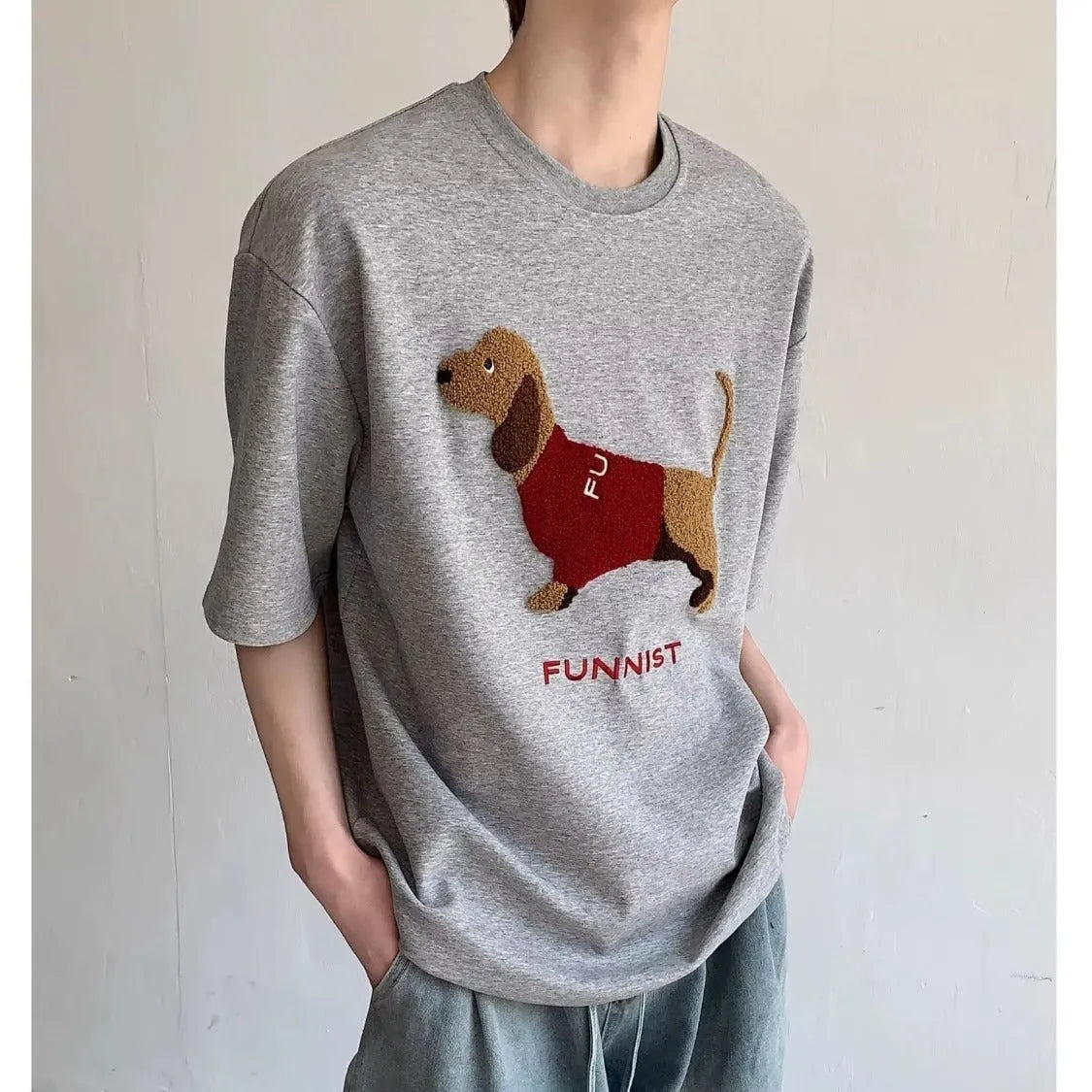 Grey men's T-shirt with a raised towel embroidery sausage dog design on the chest.