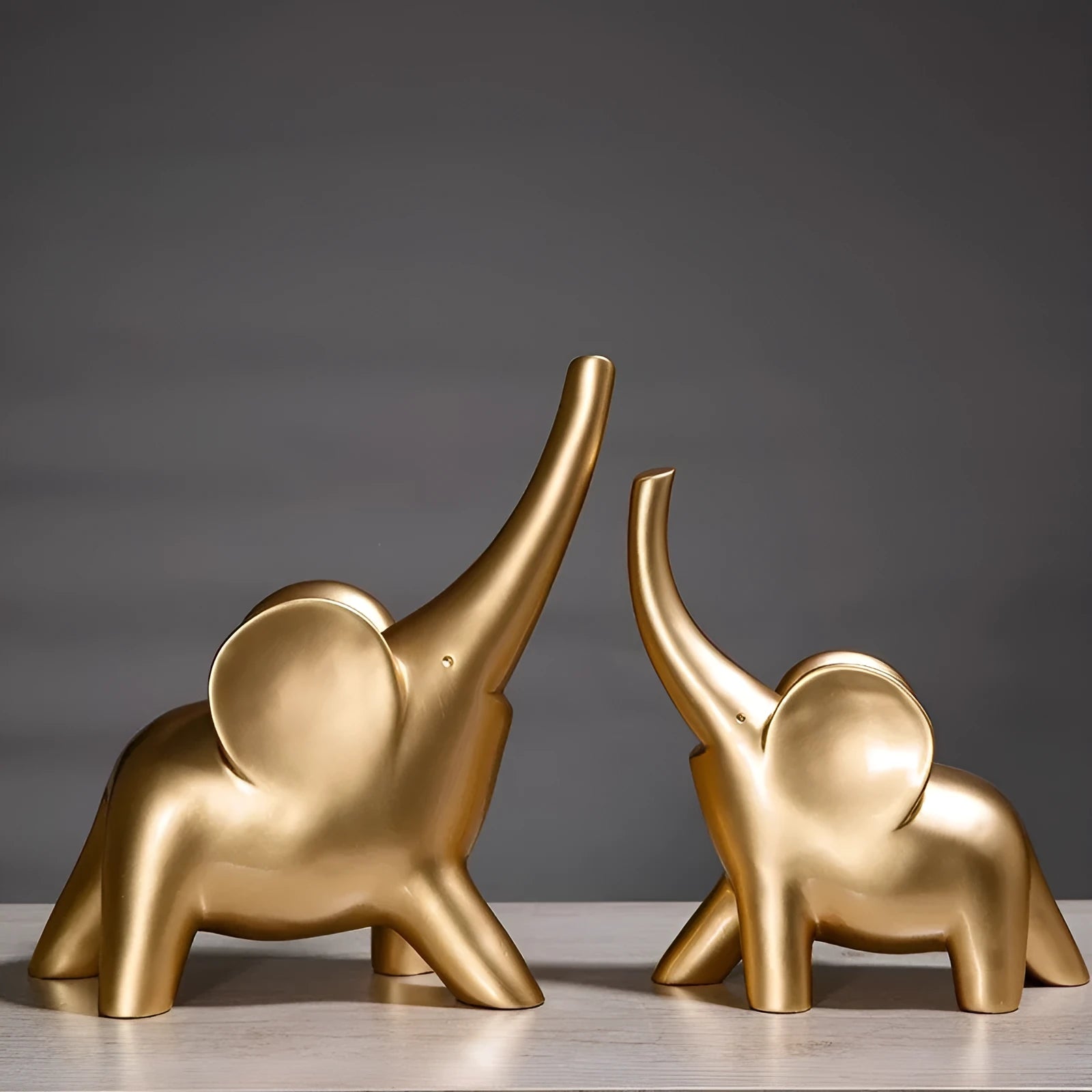Modern resin elephant ornament in rose gold colour displayed on wooden surface