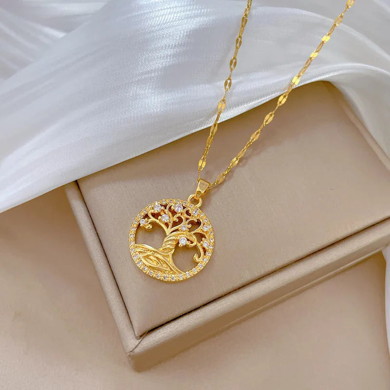 Gold-plated cross necklace with mother-of-pearl lucky tree pendant and rhinestone detailing on adjustable lip chain
