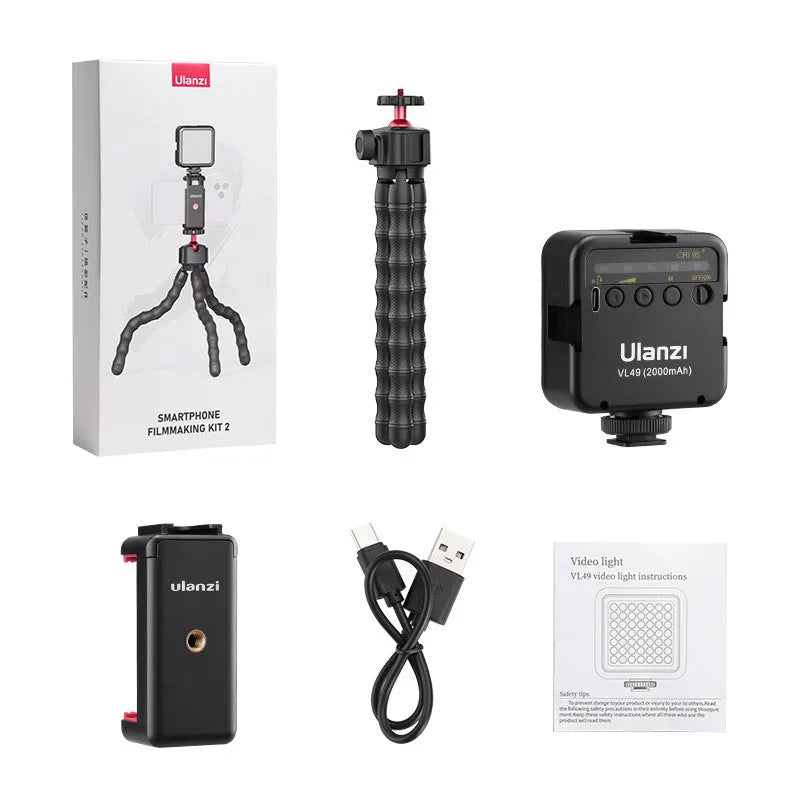 Vlog tripod kit with extended legs and a detachable Bluetooth remote shutter for mobile phone filming.