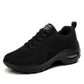 Women's black mesh sneakers with front lace-up and round toe, showing mid-heel profile