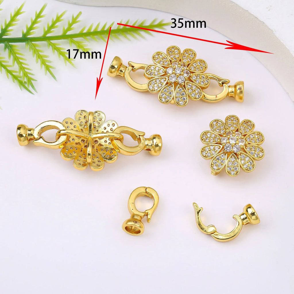 Small gold colour metal chain buckle for DIY necklace making on a white background.