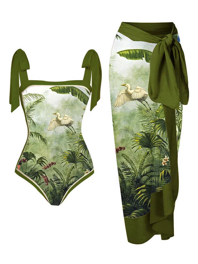 Women's floral print two-piece swimsuit with a blue chiffon skirt laid flat.