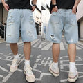Light blue distressed denim shorts with ripped detailing and straight cut hip hop style