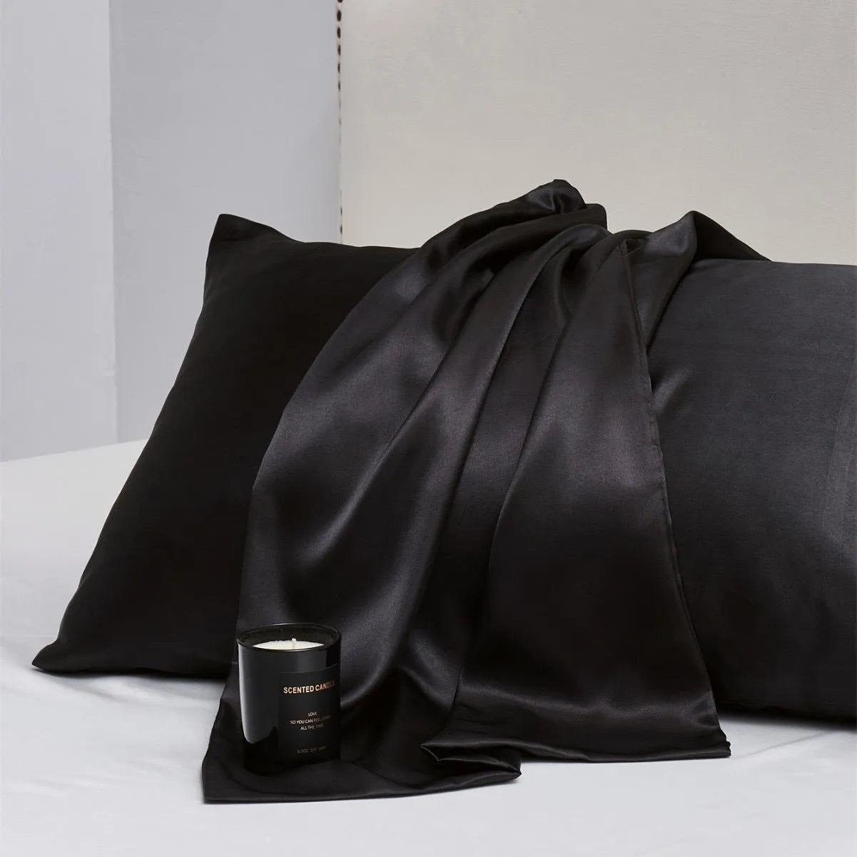 A pair of solid colour satin pillowcases in a chosen shade, showing the smooth plain weave fabric texture.