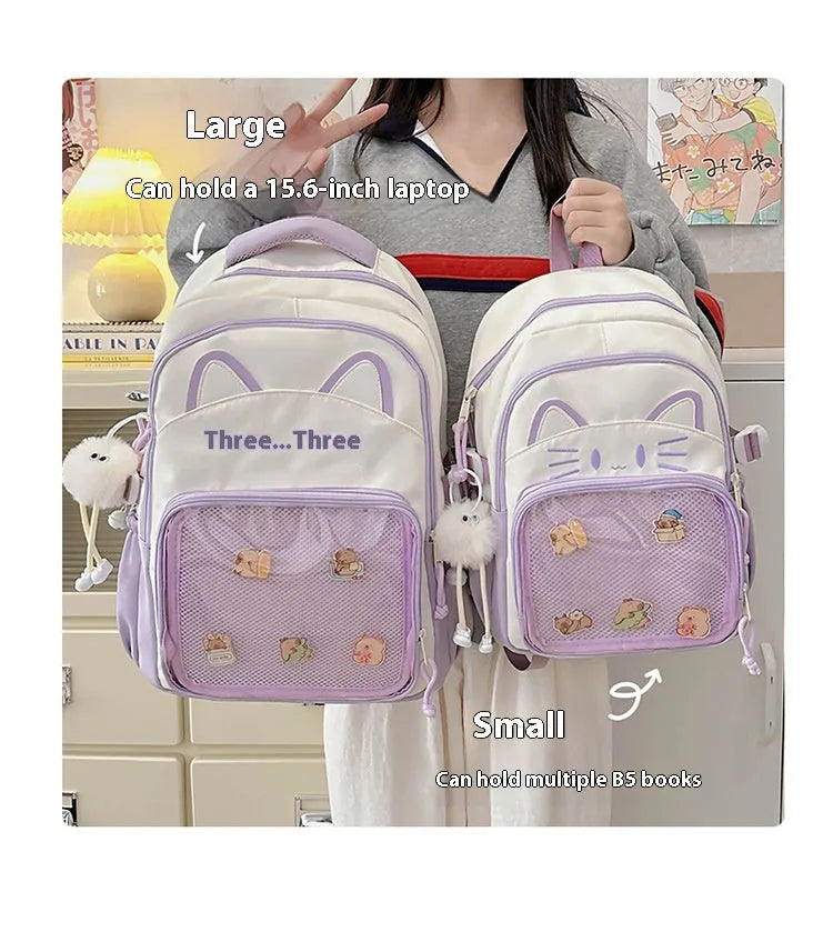 Cartoon print large capacity nylon backpack in pink with badge pendant, shown with curved shoulder straps.