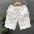 Men's black and white striped casual shorts with elastic waistband, shown on a hanger.