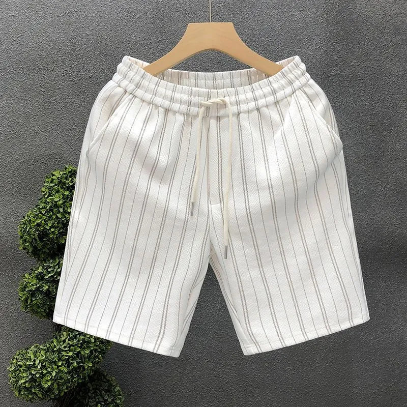 Men's black and white striped casual shorts with elastic waistband, shown on a hanger.