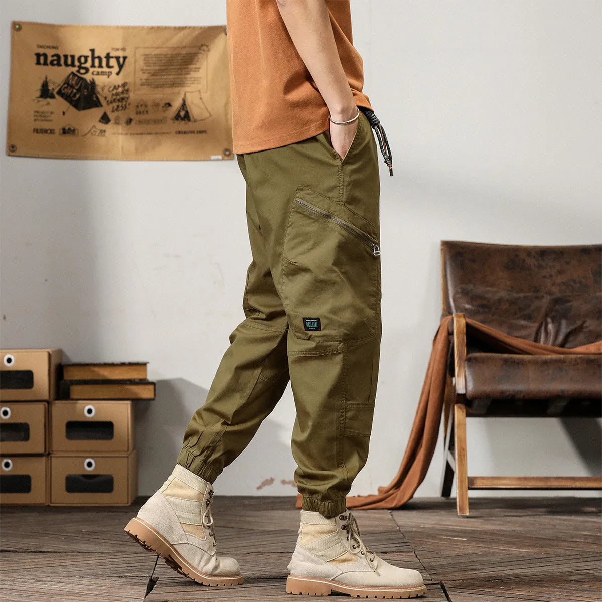 Men's khaki cotton harem pants with tapered ankle bands and a mid-waist zip fly.