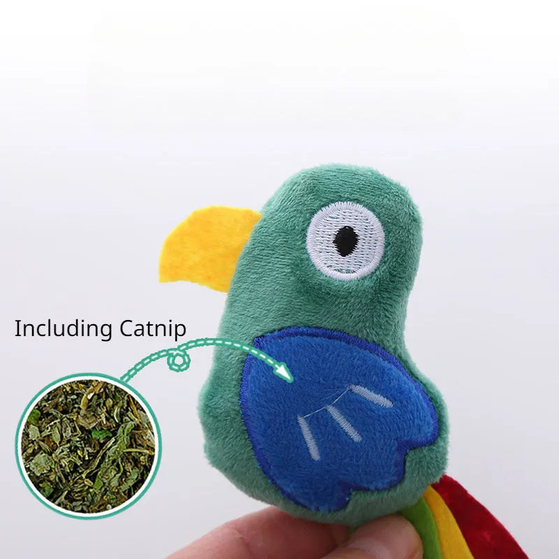 Colourful plush cat toy shaped like a cow, a crocodile, or a parrot on a plain background.