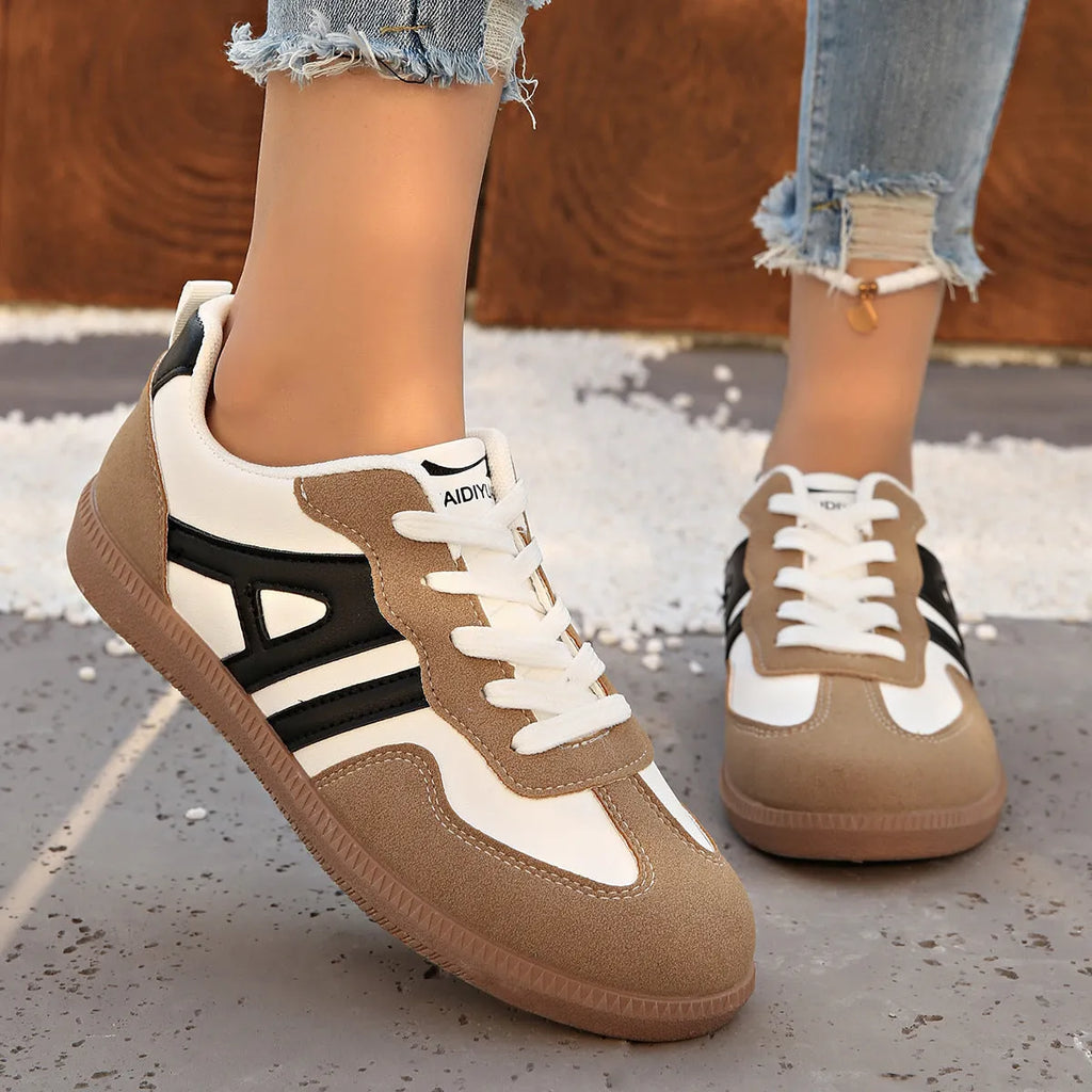 Women's retro grey jogging shoes with lace-up front and cross-strap detail on a rubber platform sole.