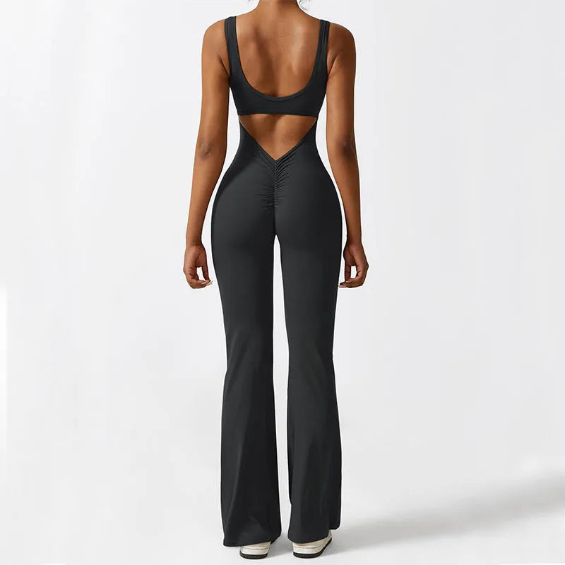 Woman wearing a sleeveless flare-leg jumpsuit for yoga in Army Green, showcasing the fashionable waist and full length.