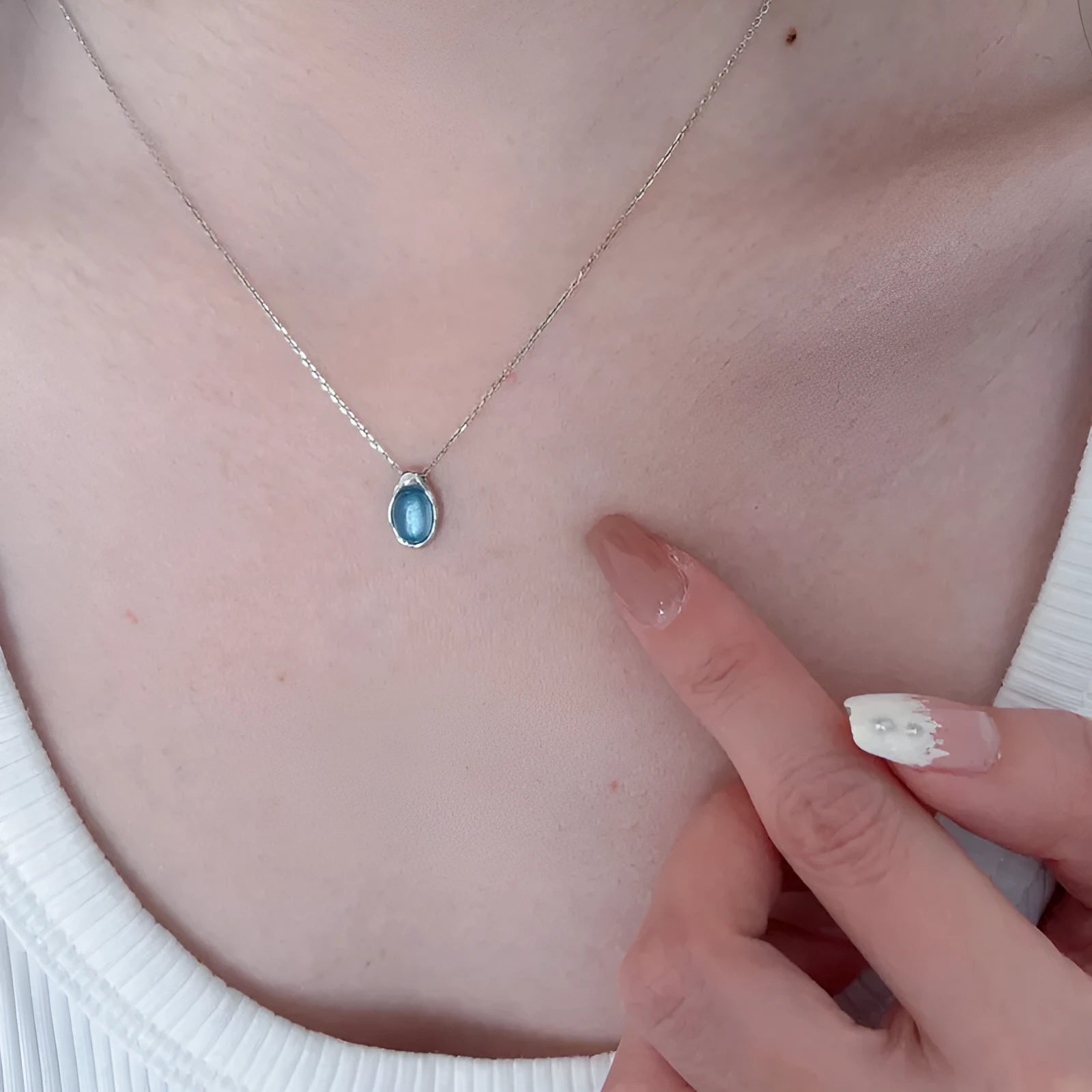 Women's navy blue water drop pendant necklace on adjustable copper cross chain