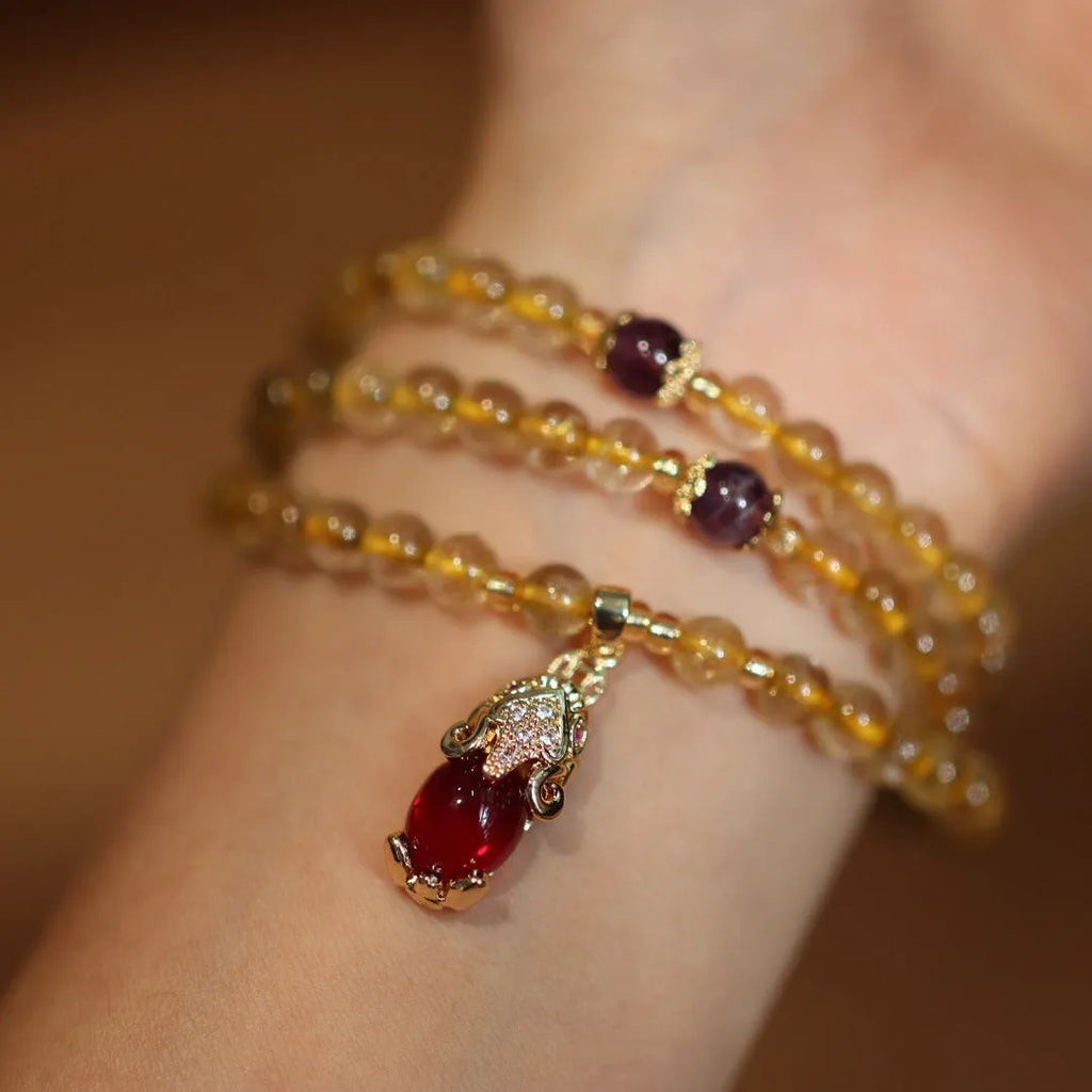 Natural rutilated quartz bracelet with gold rutile inclusions and Chinese style gold accent beads