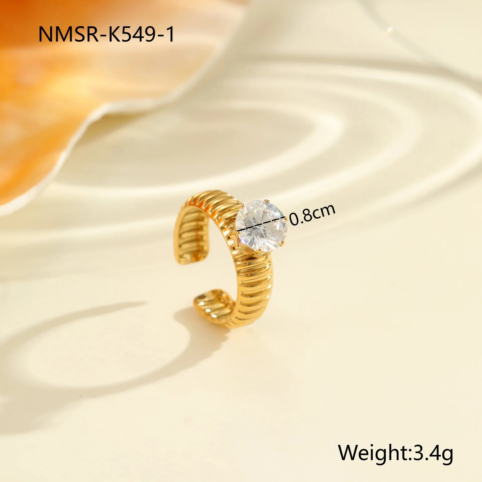Gold-plated geometric stainless steel ring with inlaid zircon stones on a white background.