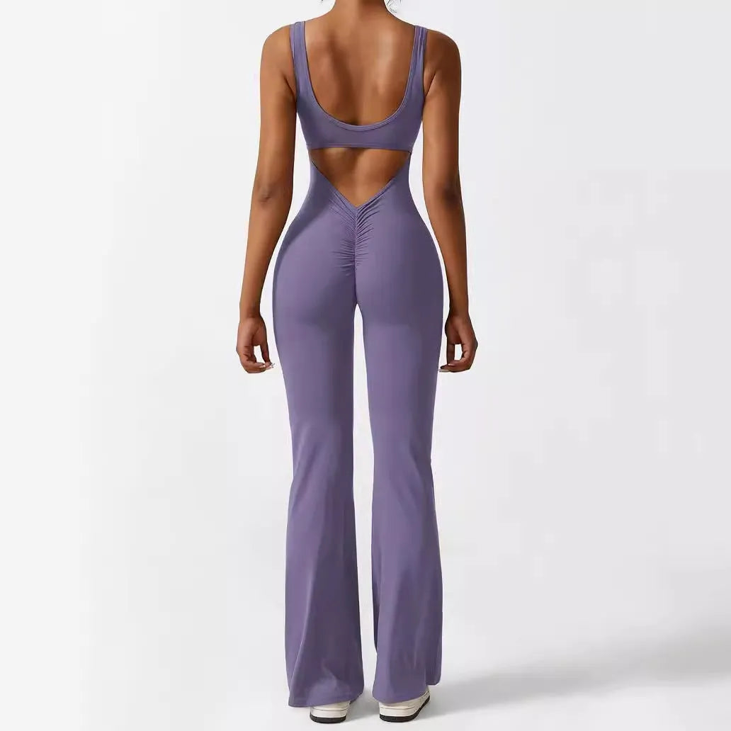 Woman wearing a sleeveless flare-leg jumpsuit for yoga in Army Green, showcasing the fashionable waist and full length.