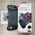 Black and white Nintendo Switch gamepad handle with console inserted, showing button layout and USB-C charging port