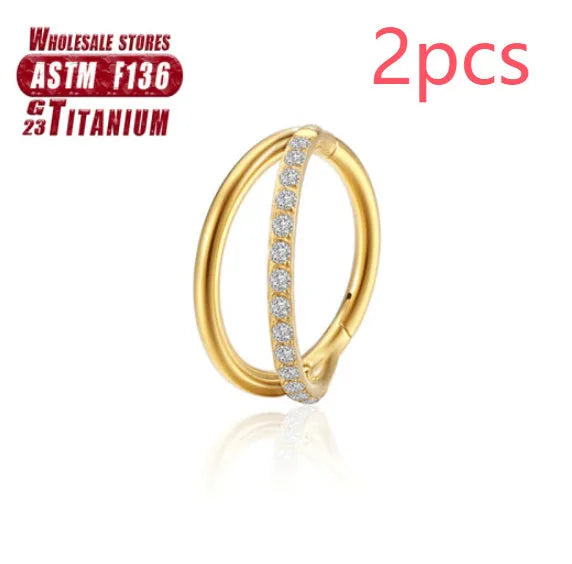 Titanium alloy nose ring on a plain background, shown in silver and gold finishes.