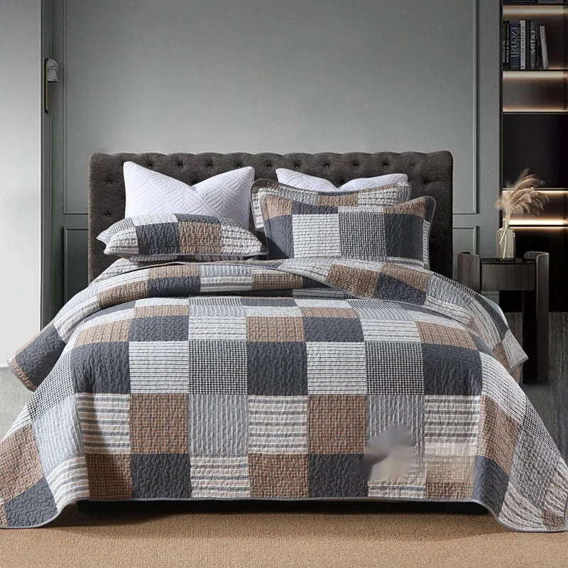 Quilted pure cotton bed cover set with printed pattern on a bed, includes two matching pillowcases.