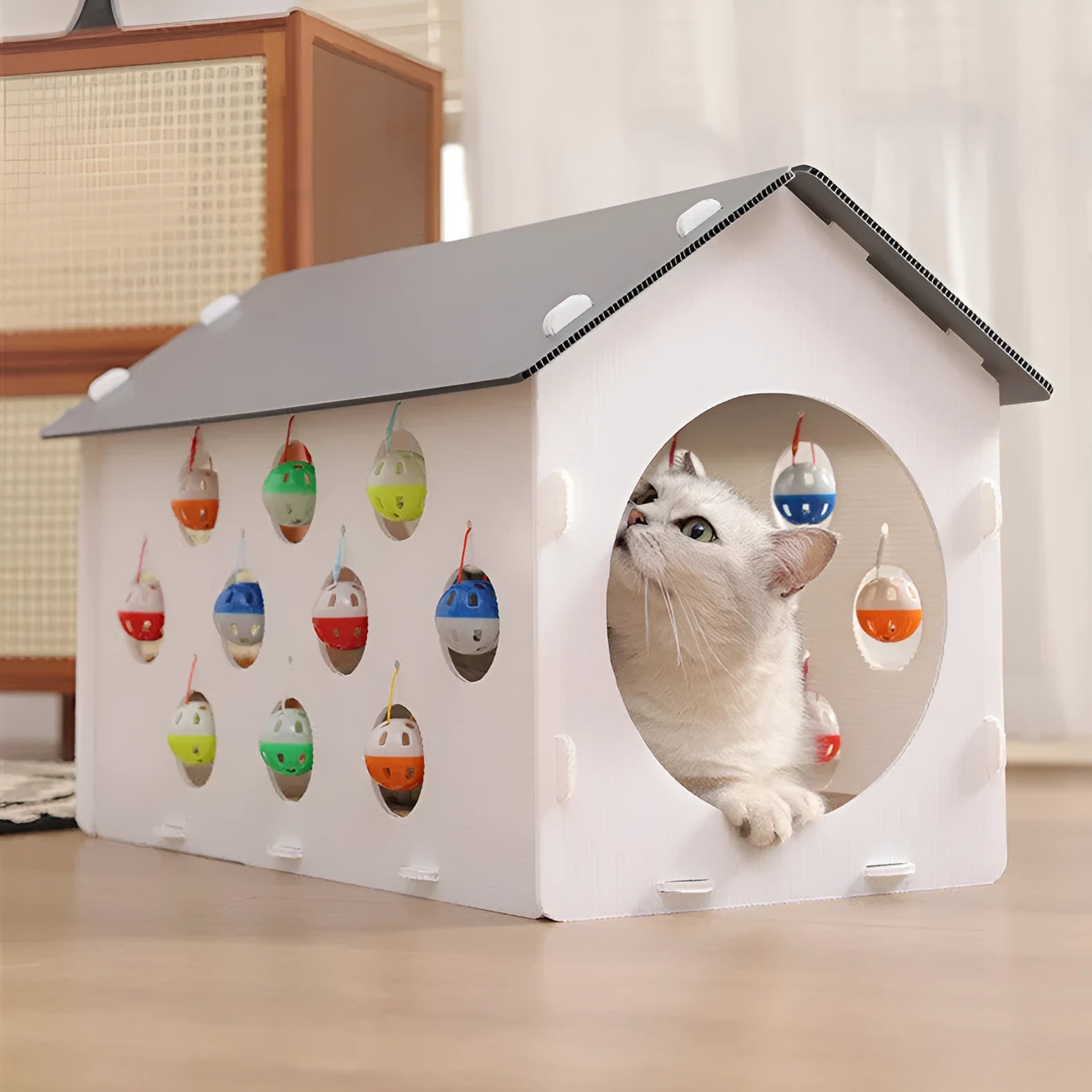 Integrated cat scratch board with resting nest, play tunnel, and bell ball toy