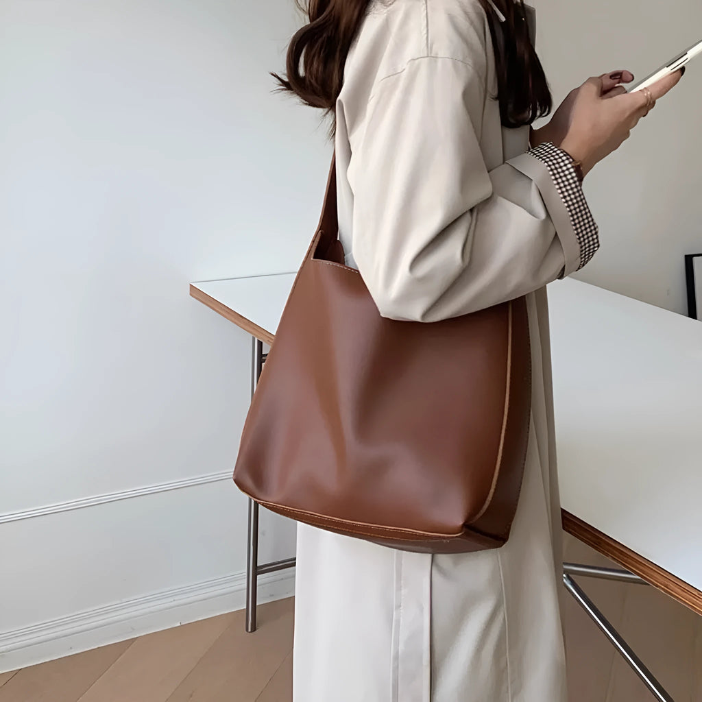 Women's soft PU leather shoulder bag with decorative threads measuring 28x32x12cm in black and brown colour options