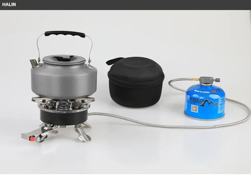 Silver portable folding camping gas stove made of stainless steel and copper with a long black hose.