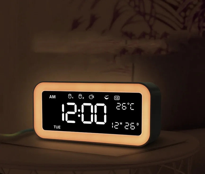 Blue rectangular LED alarm clock with atmosphere lighting on a wooden desk.
