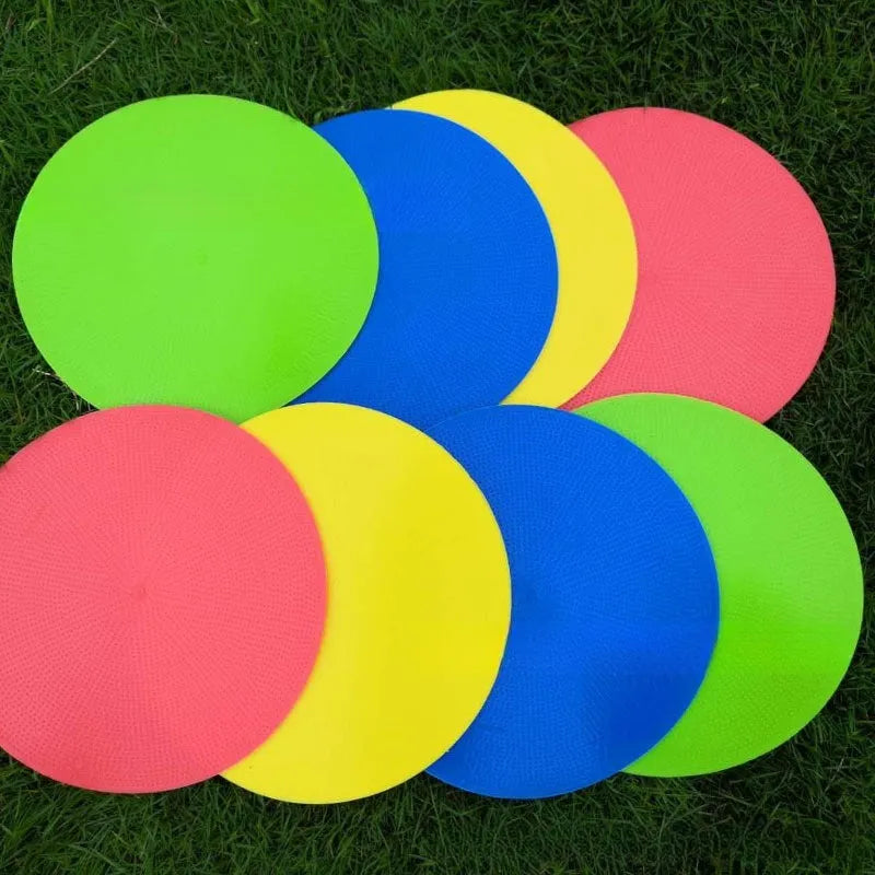 Soft yellow TPE football training landmark pad on grass, showing 23cm diameter.