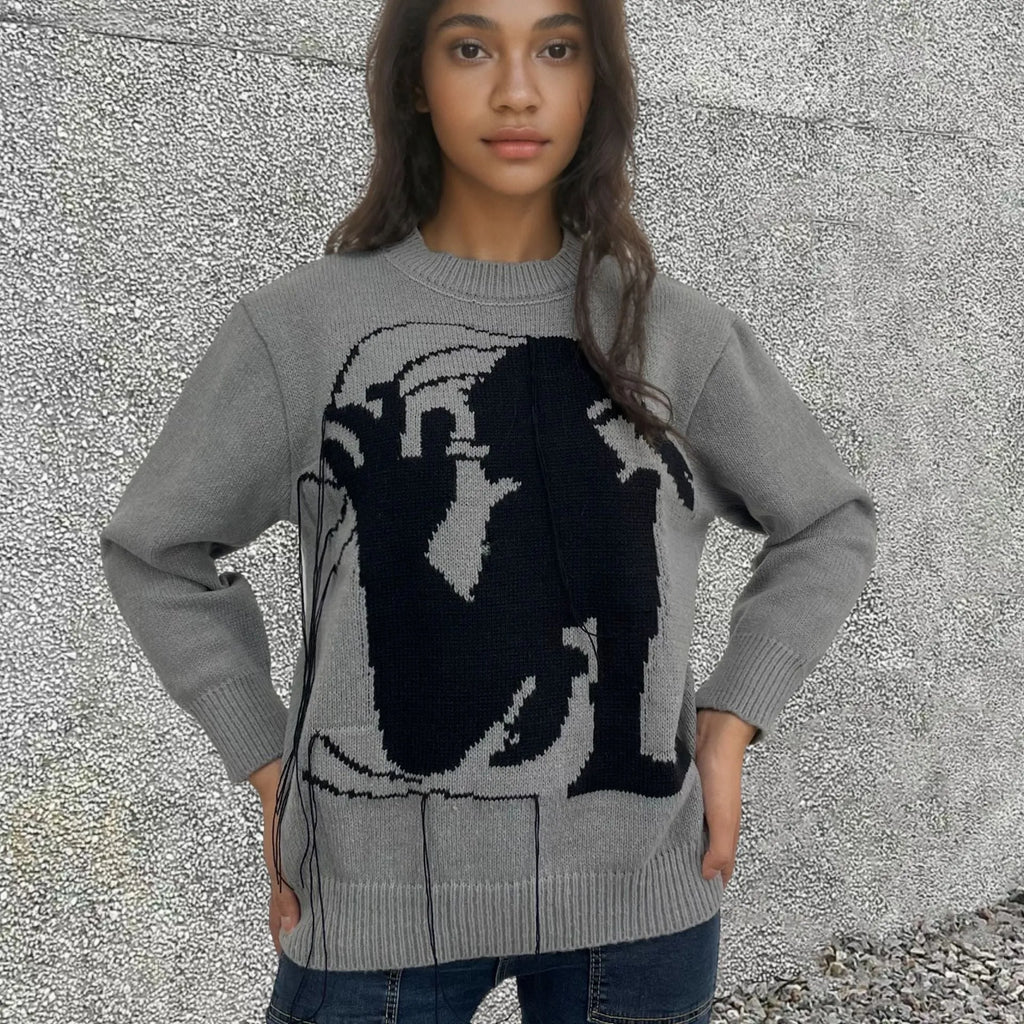 Grey alpaca wool women's sweater with abstract pattern and tassel detail on sleeve.