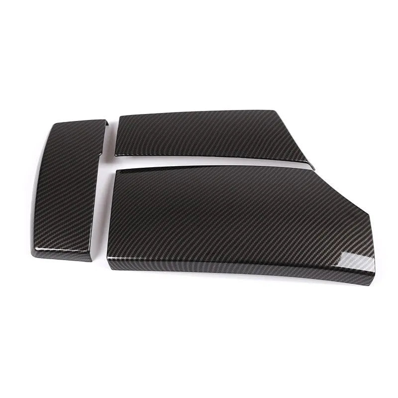 Three black ABS car armrest box covers with a shiny carbon fibre diagonal weave pattern.
