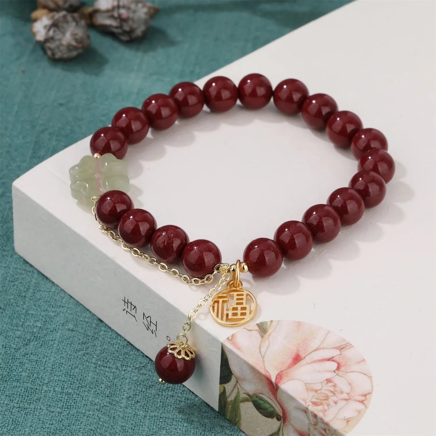 Women's cinnabar bracelet with fu character charm in purple gold sand colour and peach blossom detailing