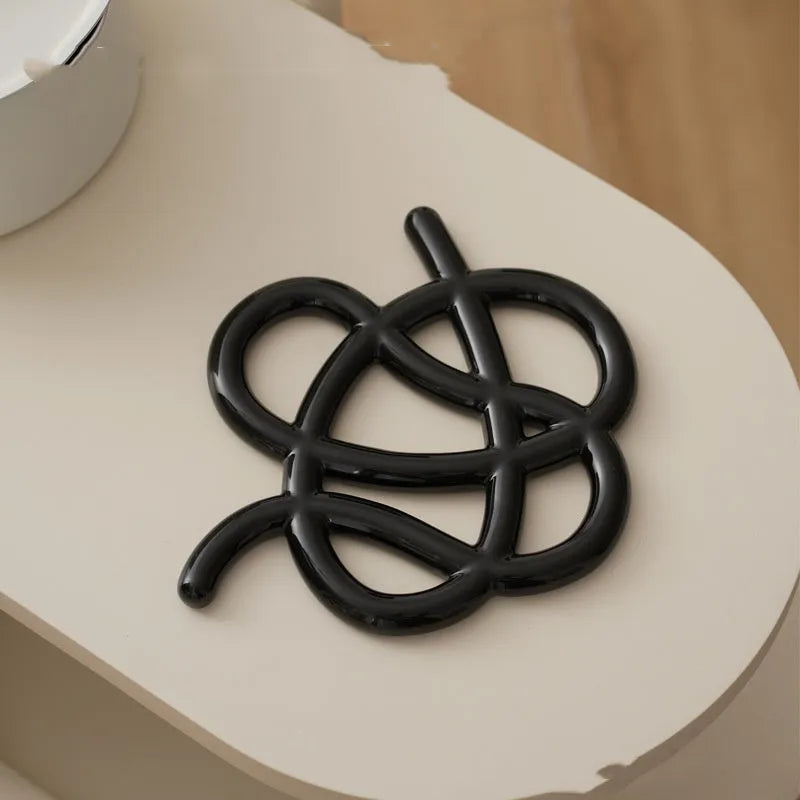 Ceramic heat proof mat with irregular shape and bend and hook design