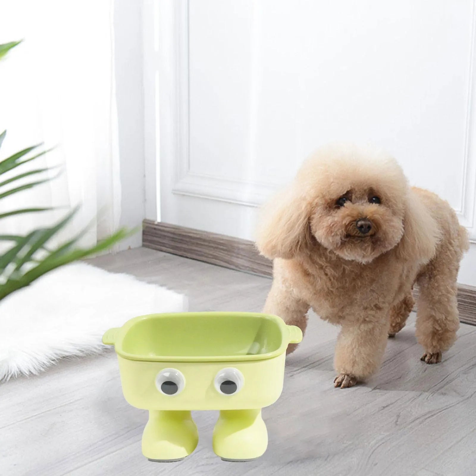 Green robot-shaped elevated cat bowl with tilted design and detachable inner dish